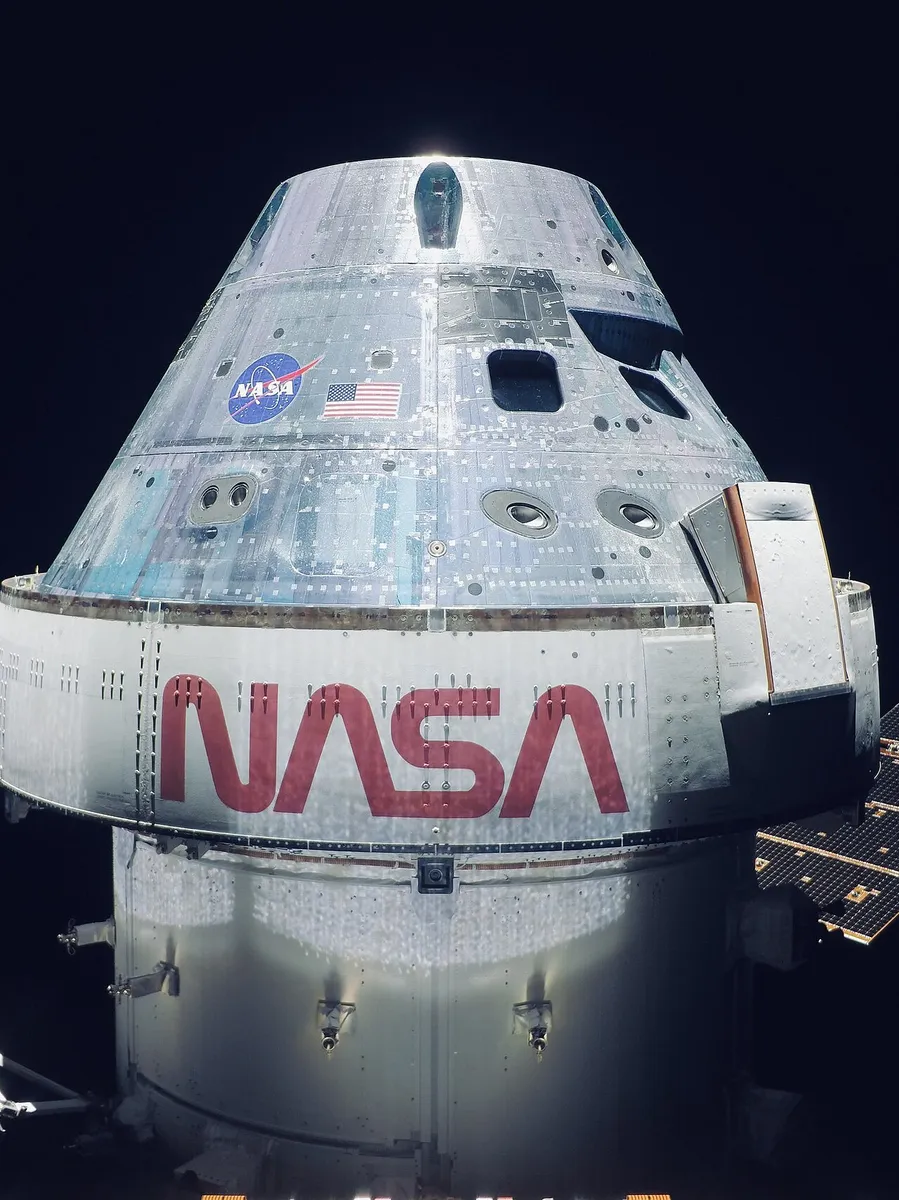 The uncrewed Orion capsule photographed by its own solar array camera halfway to the Moon during the Artemis I mission, in November 2022.